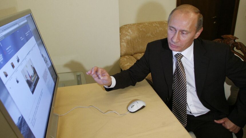 Russian Prime Minister Vladimir Putin examines his new official website in Moscow on October 31, 2008.