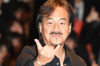 Hironobu Sakaguchi makes a hand gesture.