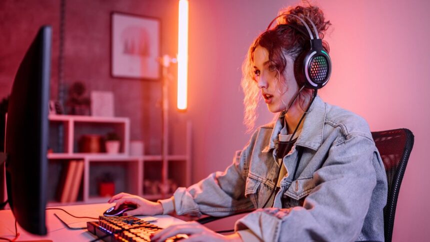 Woman gaming on a computer at home