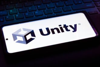 BRAZIL - 2021/10/12: In this photo illustration the Unity Technologies logo seen displayed on a smartphone on the background of a keyboard. (Photo Illustration by Rafael Henrique/SOPA Images/LightRocket via Getty Images)