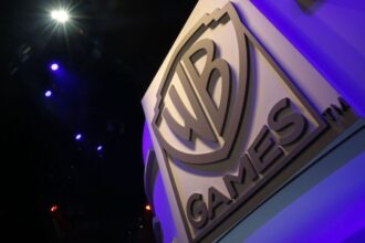 The WB Games logo is displayed during the E3 Electronic Entertainment Expo in Los Angeles, California, U.S., on Wednesday, June 17, 2015. E3, a trade show for computer and video games, draws professionals to experience the future of interactive entertainment as well as to see new technologies and never-before-seen products. Photographer: Patrick T. Fallon/Bloomberg via Getty Images