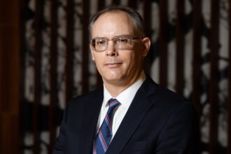 Tim Sweeney, CEO of Epic Games, looks at the camera.