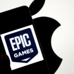 INDIA - 2024/09/14: In this photo illustration, an Epic Games logo seen displayed on a smartphone with an Apple logo in the background. The relationship between Epic Games and Apple became widely known due to a legal dispute. In 2020, Epic Games, the creator of the popular game Fortnite, challenged Apple's App Store policies by introducing a direct payment option in Fortnite, bypassing Apple's 30% commission on in-app purchases. Apple responded by removing Fortnite from the App Store, leading to a major lawsuit. Epic accused Apple of anti-competitive behavior, claiming that the company had a monopoly on app distribution and payments within its ecosystem. The case, which addressed broader issues of app store policies and digital marketplaces, attracted significant attention and sparked debate about the control tech giants have over their platforms. (Photo Illustration by Avishek Das/SOPA Images/LightRocket via Getty Images)