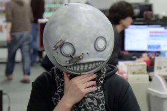 NieR creator Yoko Taro in his trademark Emil mask from the games
