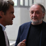 Serge Hascoët (R), former creative director of Ubisoft, speaks with his lawyer as he arrives for the trial of French video game publisher Ubisoft Entertainment former executives for harrasment and sexual assault at the courthouse in Bobigny, suburb of Paris, on June 2, 2025.