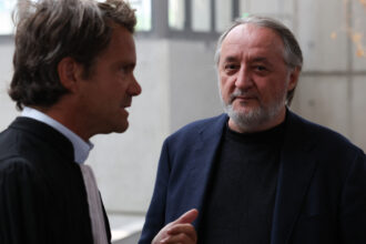 Serge Hascoët (R), former creative director of Ubisoft, speaks with his lawyer as he arrives for the trial of French video game publisher Ubisoft Entertainment former executives for harrasment and sexual assault at the courthouse in Bobigny, suburb of Paris, on June 2, 2025.