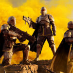 A quarter of Helldivers pose triumphantly after killing a Terminid foe.