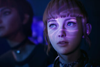 A young woman's face bathed in light